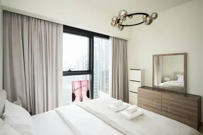 a bedroom with a large bed and a mirror at High-Rise Apartment by Burj and Fountain in Dubai