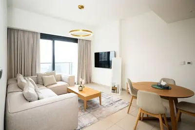 a living room with a couch and a table at High-Rise Apartment by Burj and Fountain in Dubai