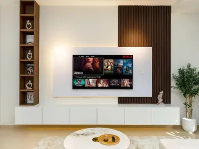 a living room with a flat screen tv on a wall at Comfy 2BR Amwaj 4 Sleeps 10 in Dubai