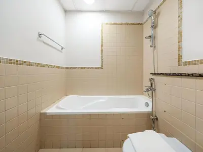 a bathroom with a bath tub and a toilet at Comfy 2BR Amwaj 4 Sleeps 10 in Dubai