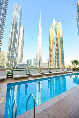 a swimming pool in a city with tall buildings at Modern 1BR in ACT Tower 1 in Dubai