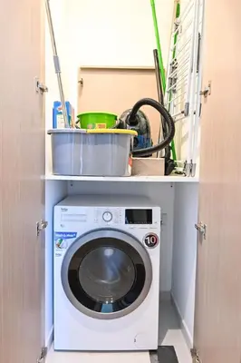 a washer and dryer in a utility room at Modern 1BR in ACT Tower 1 in Dubai