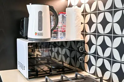 a coffee maker sitting on top of a microwave at Modern 2BR Golfville Dubai in Dubai