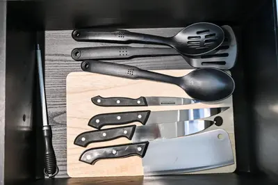 a group of knives and spatulas in a box at Modern 2BR Golfville Dubai in Dubai