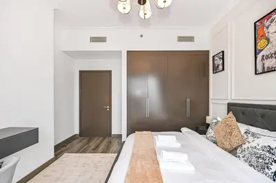 a bedroom with a large bed in a room at 2BR Pool Burj View Dubai Mall in Dubai