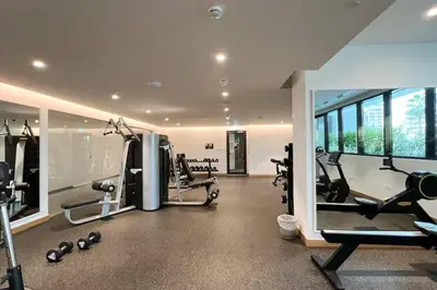 a gym with treadmills and cardio equipment in a building at Waterfront 1 BR - Canal View - Fully Furnished - Business Bay - 15 Mins to Dubai Mall and Burj Khalifa in Dubai