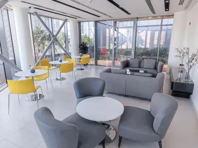 a large room with tables and chairs and windows at Stunning 1 Bedroom at Boulevard Point with Infinity Pool connected to Dubai Mall by Luxury Space in Dubai