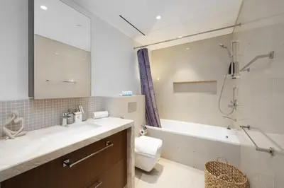 a bathroom with a tub and a sink and a toilet at Stunning 1 Bedroom at Boulevard Point with Infinity Pool connected to Dubai Mall by Luxury Space in Dubai