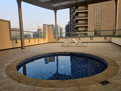 a swimming pool on the roof of a building at Best Deal I Spacious Apartment I Full Amenities including Balcony, Pool, Gym, Kids Play Area in Dubai
