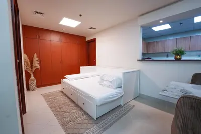 a hospital room with a white bed and red cabinets at Best Deal I Spacious Apartment I Full Amenities including Balcony, Pool, Gym, Kids Play Area in Dubai
