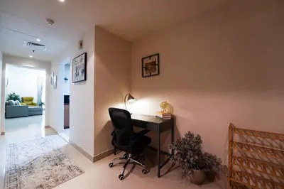 a home office with a desk and a chair at Best Deal I Spacious Apartment I Full Amenities including Balcony, Pool, Gym, Kids Play Area in Dubai