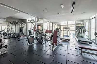 a gym with several treadmills and machines at Studio Steps from JBR Beach and Marina Walk, Conveniently located near Ain Dubai, Dec Towers T2, Dubai Marina by Deluxe Holiday Homes in Dubai