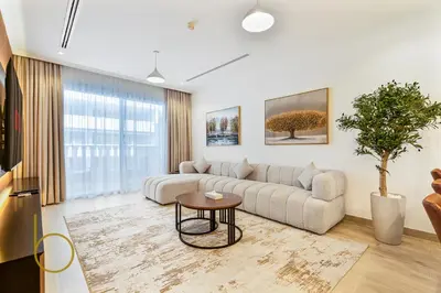a living room with a couch and a table at Bookable - 3 Bedroom in Mayas Geneva, JVC in Dubai