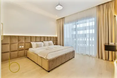 a bedroom with a large bed and a large window at Bookable - 3 Bedroom in Mayas Geneva, JVC in Dubai
