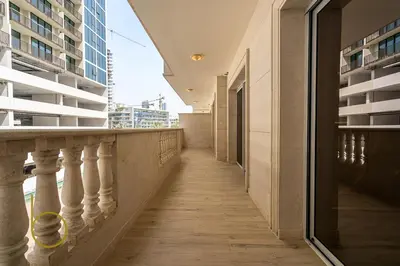 a corridor of an office building with a balcony at Bookable - 3 Bedroom in Mayas Geneva, JVC in Dubai