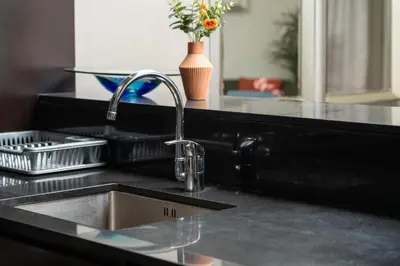 a kitchen counter with a sink and aaucet at Full Burj Khalifa Panoramic View - Luxury Stay at Damac Maison Distinction in Dubai