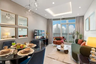 a living room with a couch and a table at Full Burj Khalifa Panoramic View - Luxury Stay at Damac Maison Distinction in Dubai