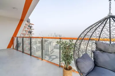 a balcony with a swing and a couch at Full Dubai Skyline View on High Floor in Dubai