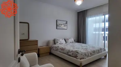 a bedroom with a bed and a dresser and a mirror at Amazing 3 bedrooms in Mayas geneva in Dubai