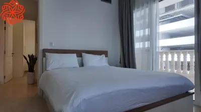a bedroom with a white bed and a large window at Amazing 3 bedrooms in Mayas geneva in Dubai