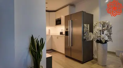a kitchen with a stainless steel refrigerator in a room at Amazing 3 bedrooms in Mayas geneva in Dubai