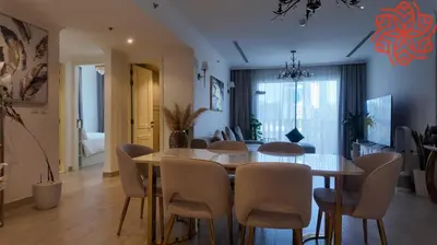 a dining room with a table and chairs at Amazing 3 bedrooms in Mayas geneva in Dubai