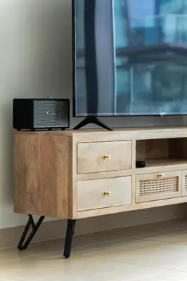 a television on top of a wooden dresser at Design 1br Apartment with Dubai Marina View in Marina Gate 2 in Dubai