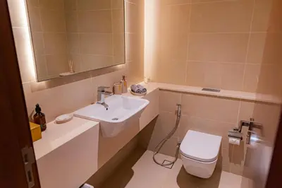 a bathroom with a sink and a toilet and a mirror at Design 1br Apartment with Dubai Marina View in Marina Gate 2 in Dubai