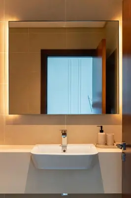 a white sink in a bathroom with a mirror at Design 1br Apartment with Dubai Marina View in Marina Gate 2 in Dubai