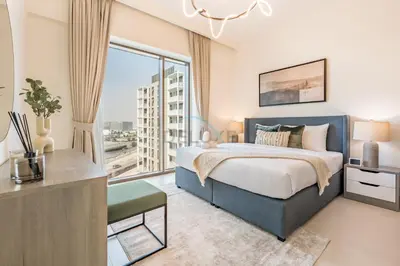 a bedroom with a large bed and a large window at Creek Views 1BR, Short Drive to Ras Al Khor Sanctuary and Festival City Mall, Rosewater at Creek Beach Building 3, Dubai Creek Harbour by Deluxe Holiday Homes in Dubai