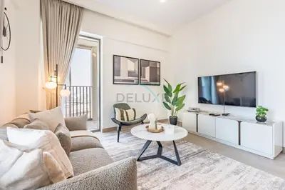 a living room with a couch and a table at Creek Views 1BR, Short Drive to Ras Al Khor Sanctuary and Festival City Mall, Rosewater at Creek Beach Building 3, Dubai Creek Harbour by Deluxe Holiday Homes in Dubai
