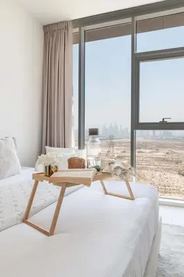 a bed with a wooden tray on top of it at Frank Porter - Bloom Tower C in Dubai