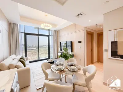 a living room with a table and chairs at Elegant 1BR at Azizi Riviera l Prime Location in Dubai