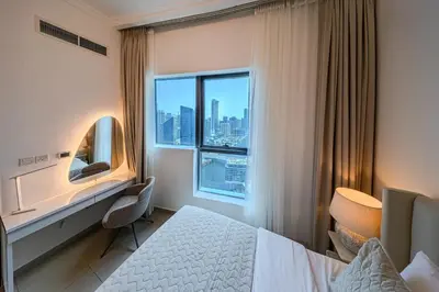 a hotel room with a bed and a window at 1BD Canal View for 4 in Bay Central, Dubai Marina in Dubai