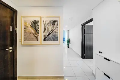 a hallway with two framed pictures on the wall at 1BD Canal View for 4 in Bay Central, Dubai Marina in Dubai