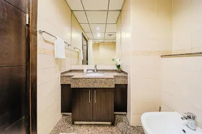 a bathroom with a sink and a mirror at 1BD Canal View for 4 in Bay Central, Dubai Marina in Dubai