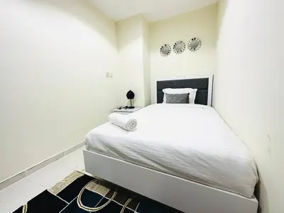 a white bedroom with a large bed in it at Stylish 1 Plus Maid's 5 mins to Metro at Marina Park in Dubai