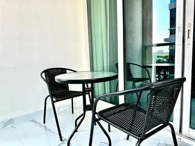 a table and two chairs and a table on a balcony at Stylish 1 Plus Maid's 5 mins to Metro at Marina Park in Dubai