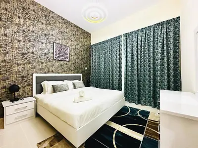 a bedroom with a large bed with a sink in it at Stylish 1 Plus Maid's 5 mins to Metro at Marina Park in Dubai
