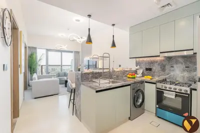 a kitchen with a sink and a stove top oven at Vogue Damac Hills Golf Gate near First Avenue Mall, Two Bedroom Apartment with Balcony and Vibrant Community View, Access to all Amenities in Dubai
