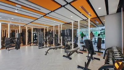 a gym with many treadmills and chairs in it at Vogue Damac Hills Golf Gate near First Avenue Mall, Two Bedroom Apartment with Balcony and Vibrant Community View, Access to all Amenities in Dubai
