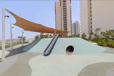 a playground with a slide and a hole in a ramp at Vogue Damac Hills Golf Gate near First Avenue Mall, Two Bedroom Apartment with Balcony and Vibrant Community View, Access to all Amenities in Dubai