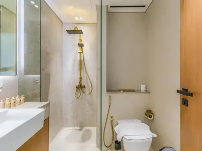 a bathroom with a shower and a toilet and a sink at TRPS - Binghatti Lavender, JVC - Premium 1BR Retreat, Fully Furnished in Dubai