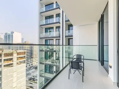 a chair on the balcony of a building at TRPS - Binghatti Lavender, JVC - Premium 1BR Retreat, Fully Furnished in Dubai