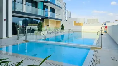 a swimming pool on the roof of a building at TRPS - Binghatti Lavender, JVC - Premium 1BR Retreat, Fully Furnished in Dubai