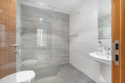 a bathroom with a shower and a toilet and a sink at Luxury Apartment l 2 min walk from Dubai Mall in Dubai