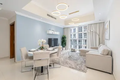 a living room with a table and a dining room at Luxury Apartment l 2 min walk from Dubai Mall in Dubai