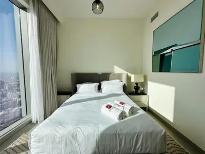 a bedroom with a bed with two towels on it at Homelike Charm High-End Furnished and Luxurious in Dubai