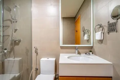 a bathroom with a toilet and a sink and a shower at Luxury Studio Apartment in Dubai