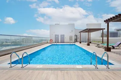 a swimming pool on the roof of a building at Luxury Studio Apartment in Dubai